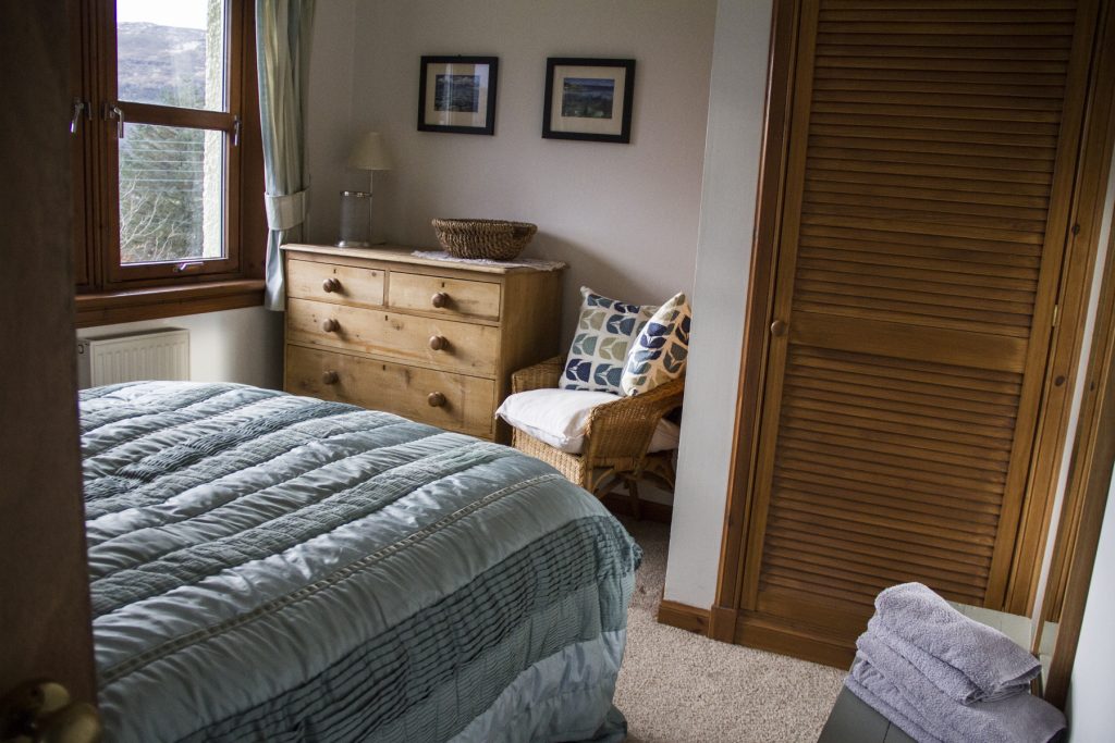 double bedroom finished with cushions and hanging photos