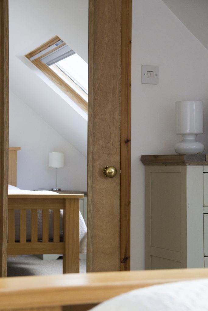 detailed image of bedroom, with mirrored door and chest of drawers